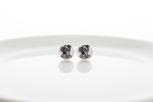 Round white stud earrings with black illustrated character design