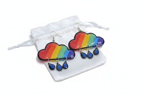 Rainbow cloud earrings with blue raindrop dangles on white satin pouch